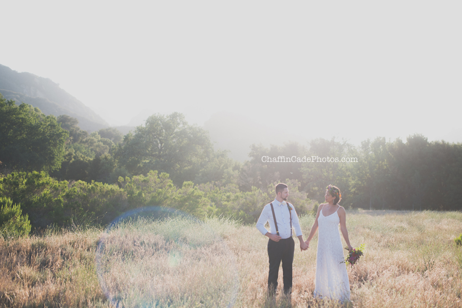 Sunday and Jaymes hold hands as the sun sets during their Malibu Creek State Park elopement in Malibu, California