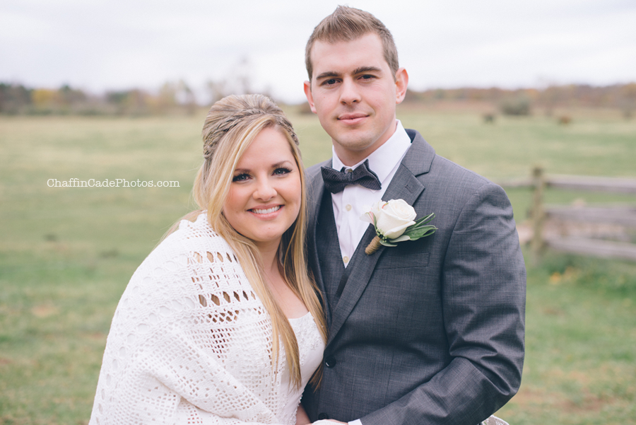 Ginger and mike stand close together on this chilly morning for their camp wedding