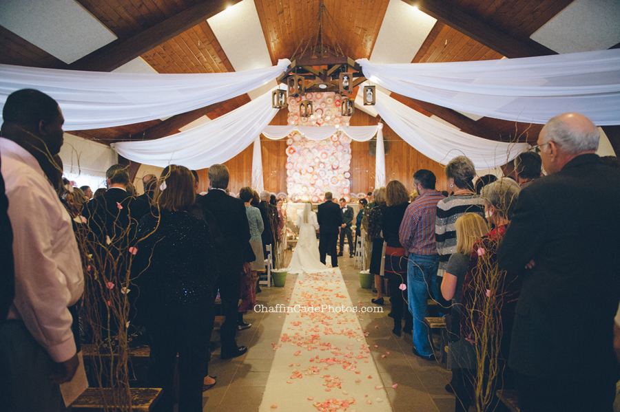 A wide shot of the lodge, all decorated with colorful fans, rose petals and other vintage decor